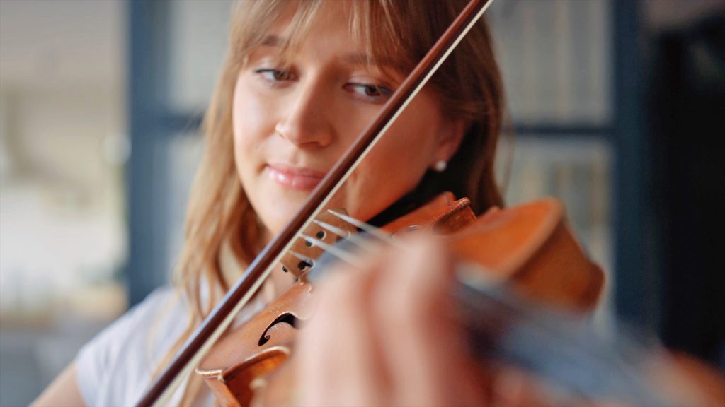 Woman playing violin with PASSION