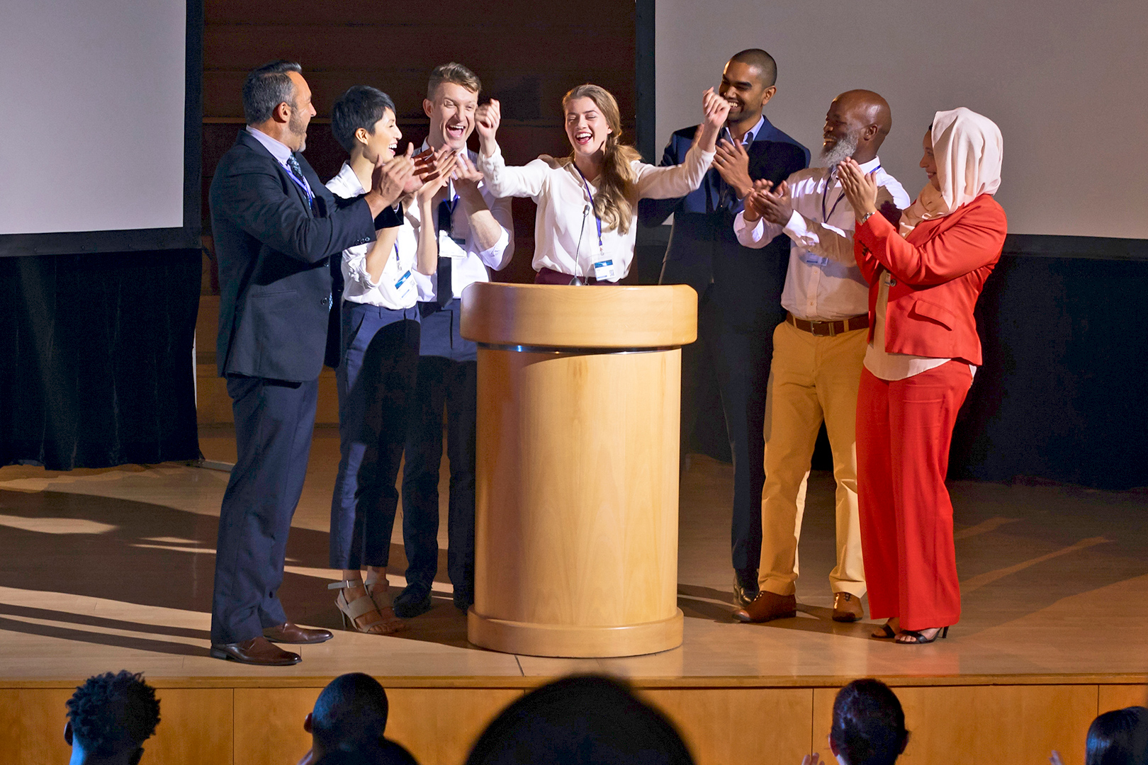 Group of people gathered on a podium at an event