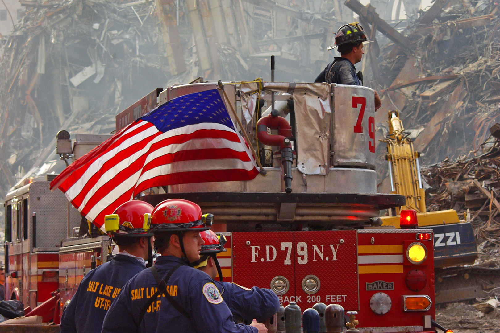 Firefighters on 9/11 with USA flag waiving on the back of the fire truck