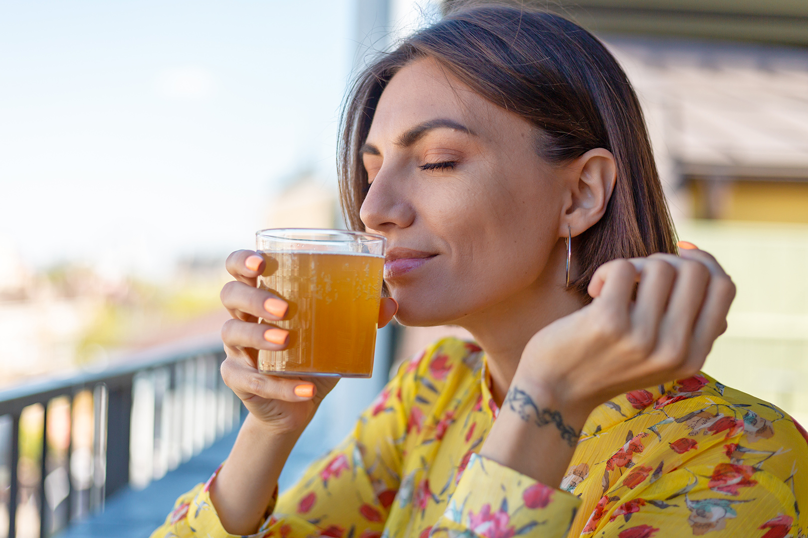 Woman Smelling a Beverage