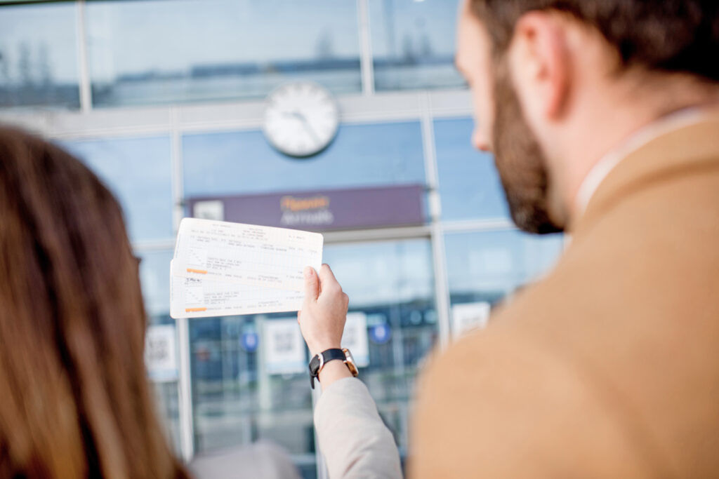 Couple holding air travel tickets