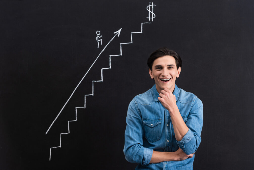 man standing in front of drawing signifying wealth growth