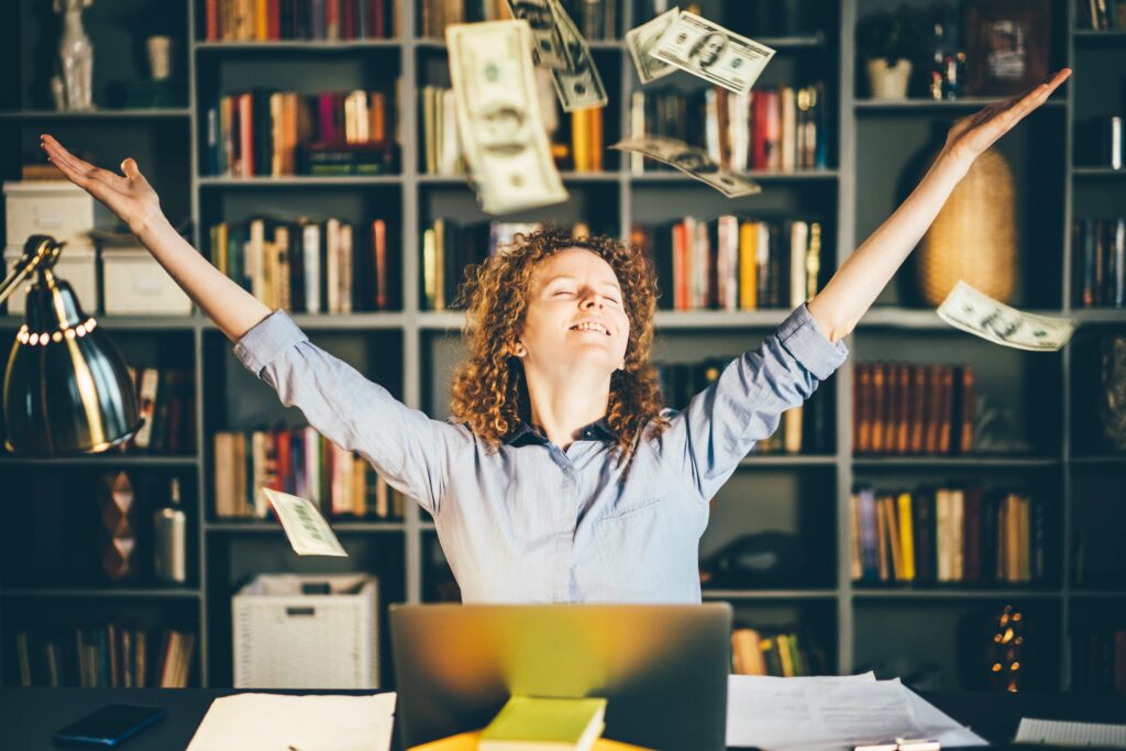 Woman with her hands in air, throwing money up in the air, top financial speakers