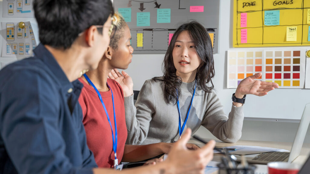 Diverse professionals collaborating in a creative workspace, reflecting teamwork, communication, and shared goals for 2026.