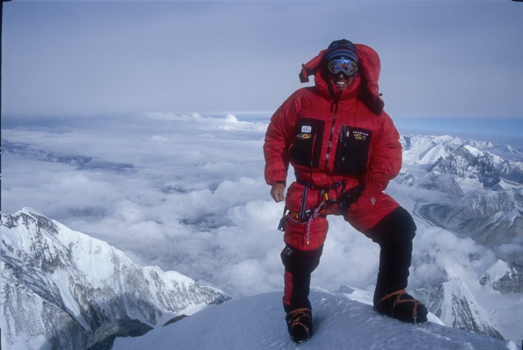 Leadership keynote speaker Ed Viesturs standing on a snow covered mountain ridge